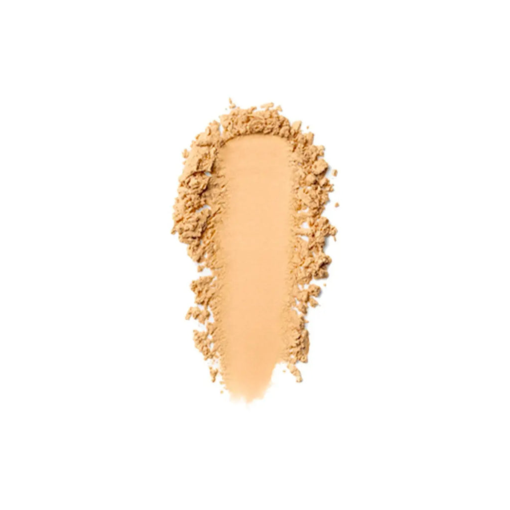 Loose setting powder swatch in a golden tone Six Beauty
