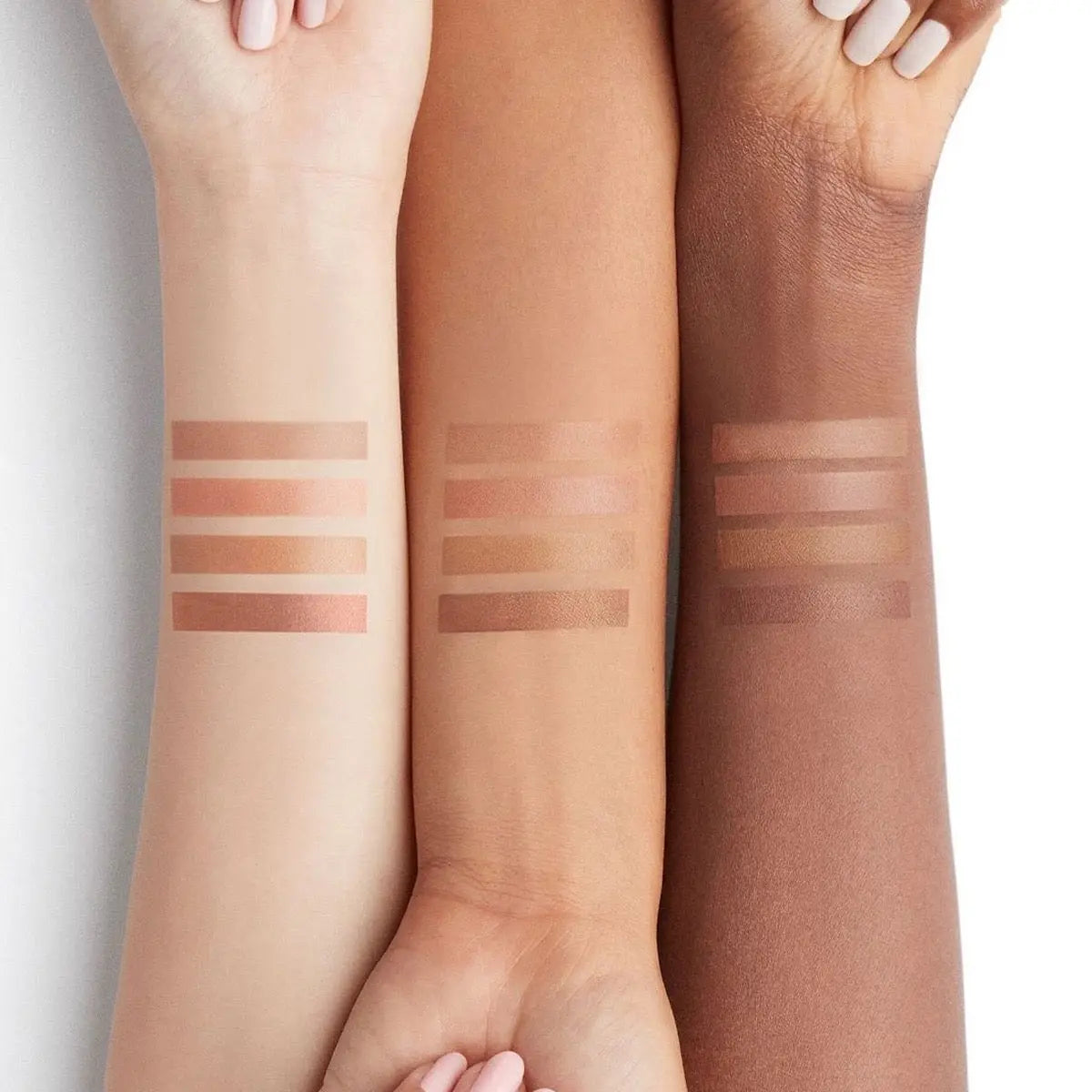 Model applying contour under cheekbones with cream palette