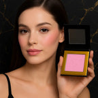Model with powder blush on cheeks holding compact | SIX BEAUTY